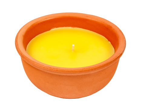 Yellow citronella candle, new, in a clay pot. A mosquito repellant for outdoor use.