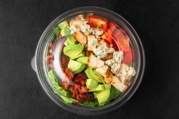 istock Plastic package with healthy cobb salad with chicken, avocado, bacon, blue cheese, tomatoes and eggs to take away 1503298005