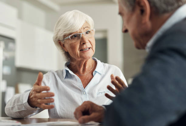 istock Retirement, life insurance documents and old couple with pension plan and policy with financial security. Savings, bills and budget, elderly woman and man at home with legal paperwork and planning 1503298590