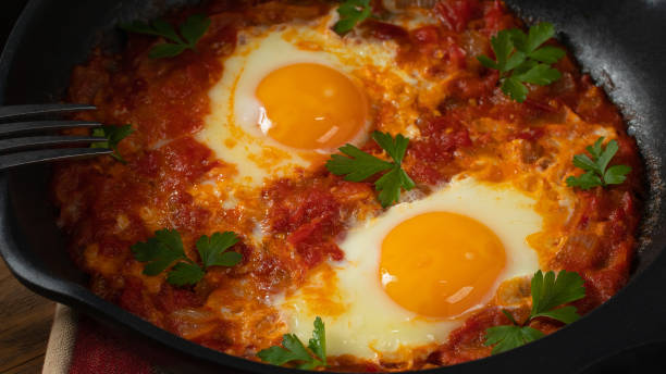 istock Two egg shakshuka in tomato sauce with fresh tomatoes, spices and herbs. Close-up scrambled eggs 1503298798