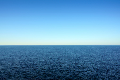 Blue sea water surface under clear sky