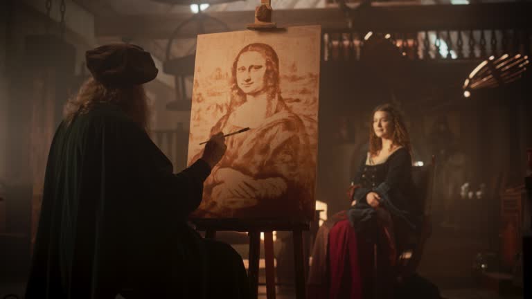 Re-enactment Documentary Scene for The Process of the Creation of the Mona Lisa Painting: The Genius Leonardo da Vinci Making the First Layer of Shadow of his Masterpiece on Canvas in his Art Workshop