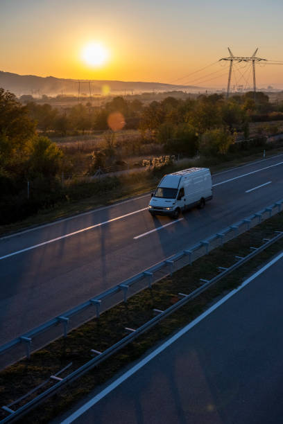 istock White delivery van on the highway. White modern delivery small shipment cargo courier van moving fast on motorway road to city urban suburb. The world's best transport of goods. 1503311148