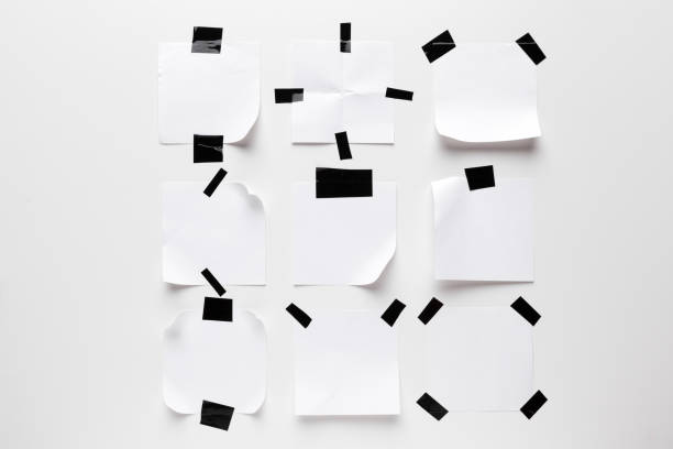 white ripped note paper stuck with black sticky tape on white background. - scrap metal audio imagens e fotografias de stock