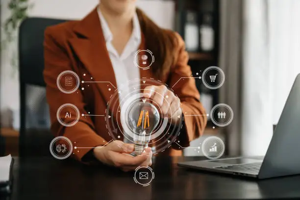 Photo of Businesswoman holding and putting lightbulb on coins stack on table for saving energy and money concept
Idea saving energy and accounting finance concept