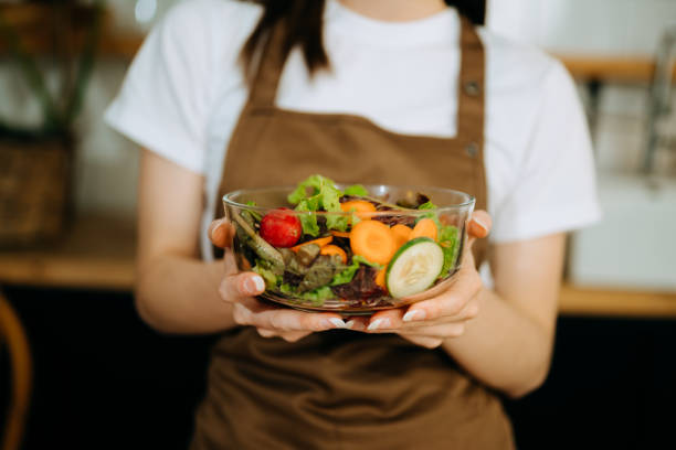 istock Fresh bell pepper holding by hand in sun light 1503315527