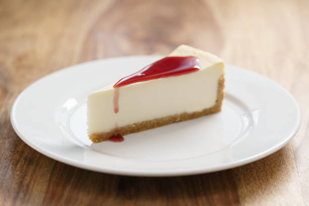 istock raditional new york cheesecake with berry jam on white plate on wood table 1503318517