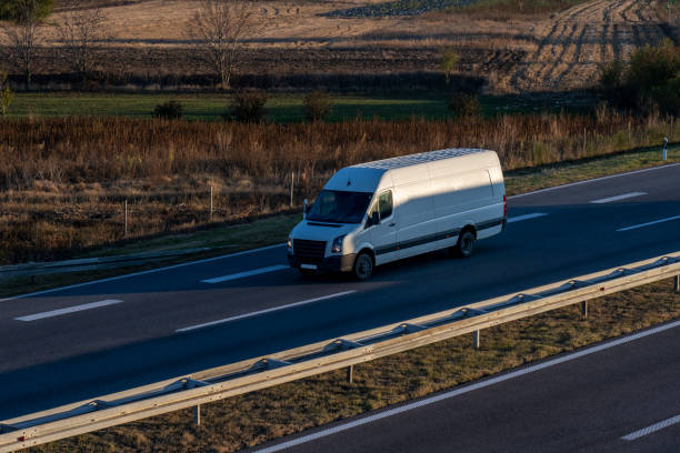 istock White delivery van on the highway. White modern delivery small shipment cargo courier van moving fast on motorway road to city urban suburb. The world's best transport of goods. 1503318912
