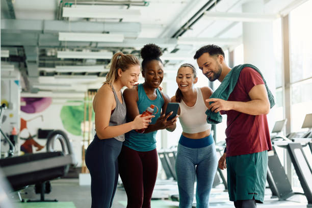 istock Young athletic friends using smart phone during gym workout. 1503324809