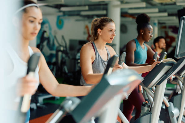 istock Group of athletes exercising on cross trainer while working out in a gym. 1503324907
