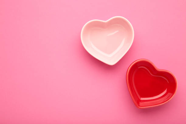 istock Red and pink heart shaped bowls on pink background. 1503325085