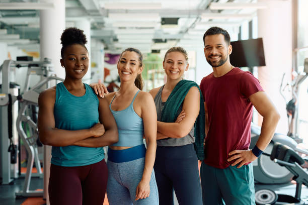 istock Group of young happy athletes in a gym looking at camera. 1503325128