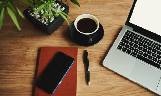business desk with laptop computer, note book and coffee, flat lay, copy space, stock photo