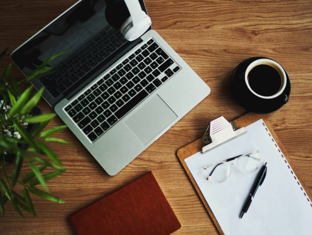 business desk with laptop computer, note book and coffee, flat lay, copy space, stock photo