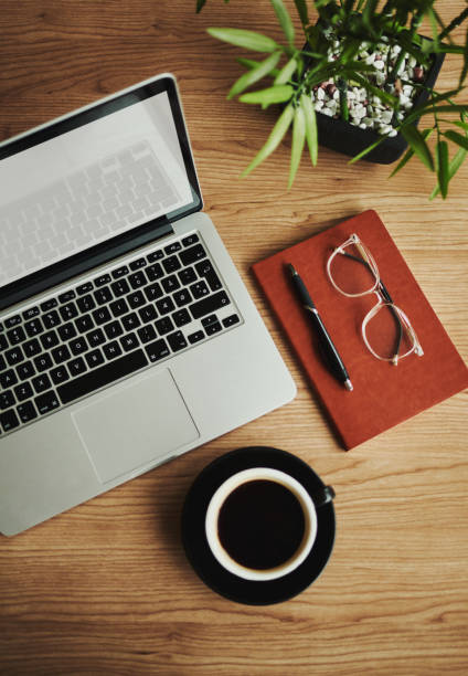istock business desk with laptop computer, note book and coffee, flat lay, copy space, stock photo 1503326539