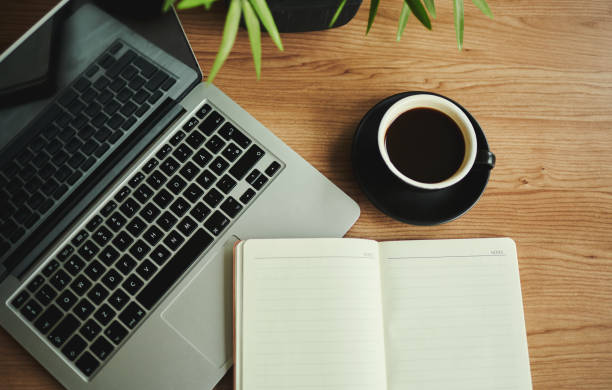 business desk with laptop computer, note book and coffee, flat lay, copy space, stock photo