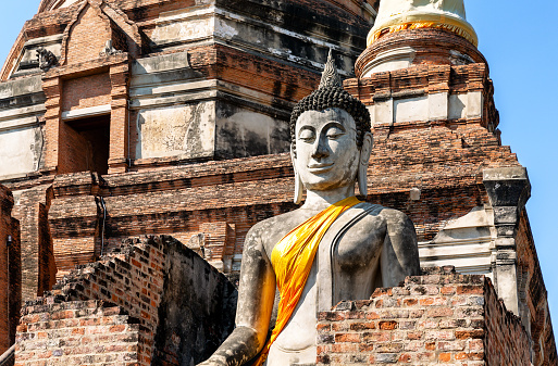 Big Buddha statue in front of temple Wat Yai Chai Mongkol (or Mongkhon) in Ayutthaya Historical Park, Ayutthaya province, Thailand. Wat Yai Chai Mongkol  is buddhist temple complex in Ayutthaya near Bangkok, Thailand.