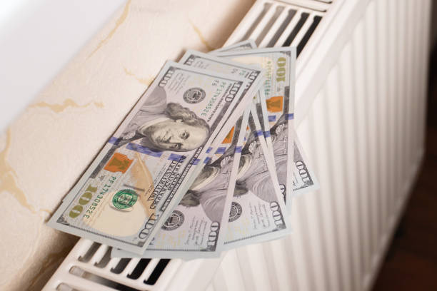 istock money on radiator, heating, rising gas prices, 1503329476