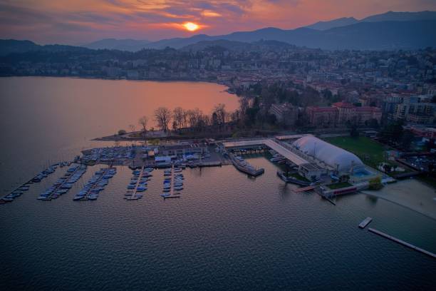 A scenic sunset over a tranquil lake in Lugano, Switzerland
