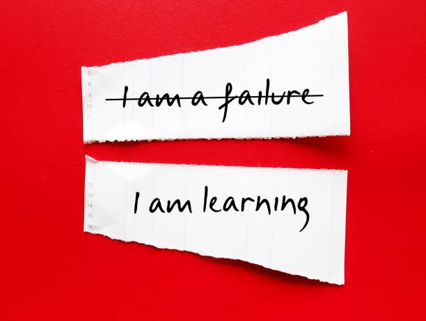 istock Torn paper stick on red background with handwriting I AM A FAILURE, corrected to I AM LEARNING, to overcome negative self talk, replace with positive thoughts, with respect and self worth 1503340521
