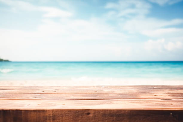 Top of wood table with seascape, blur calm sea and sky at tropical beach background. Empty table ready for your product display montage. stock photo