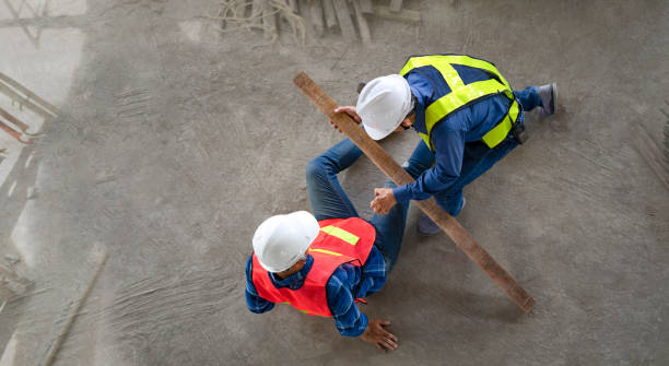 istock a piece of wood fell from height hit on a worker's legs while working at a new building, a colleague rescued him from  accident 1503343152