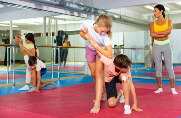 istock Kids in pair exercising self-defense movements 1503343183