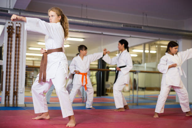 istock Girl in kimono posing during karate group training 1503343271