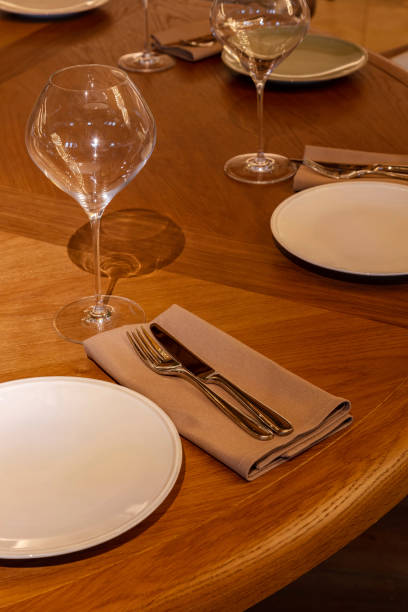 istock Table with a serving of plates, cutlery, glasses and tablecloths. 1503345611