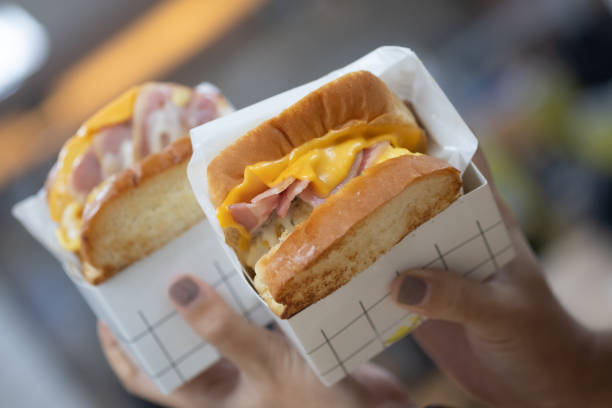 Two of Korean egg drop sandwich or scrambled egg sandwich on woman hand