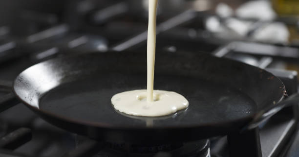 istock preparing blini or crepes batter pouring on hot pan 1503351949