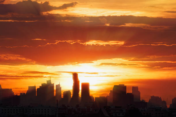 istock Sun rays  with cityscape of building silhouette. 1503353797