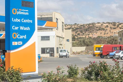 Petrol Station in Remote Location, Morocco, with cars and commercial signs visible.