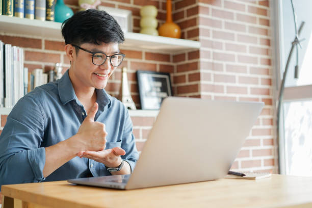 istock close up asian man make gesture hand about help sign language to teaching or learning from webinar in home for lifestyle concept 1503360946