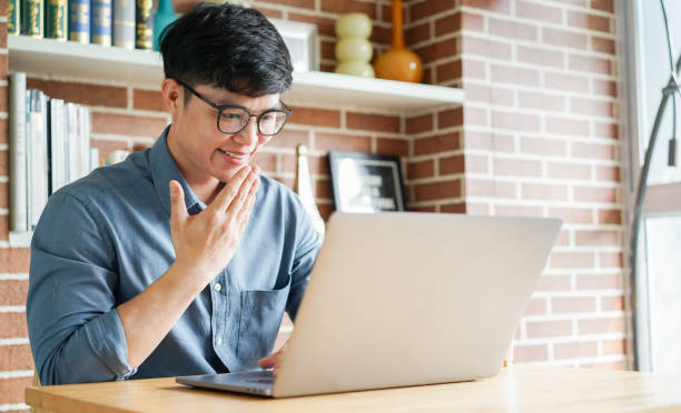 istock close up asian man make gesture hand about thank you sign language to teaching or learning from webinar in home for lifestyle concept 1503360950