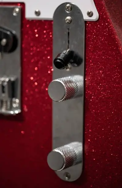 Detail of a telecaster electric guitar where we can see its pickup selector and its volume and tone potentiometers