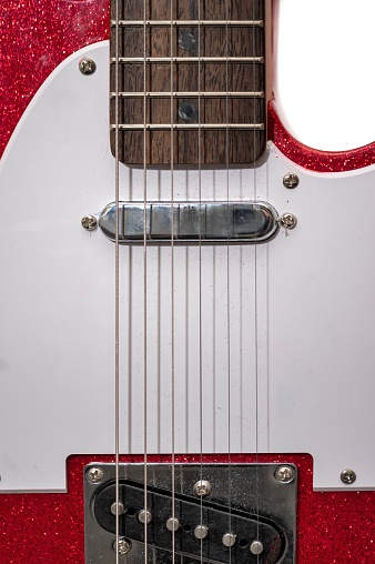 Detail of a telecaster electric guitar where we can see its strings and pickups