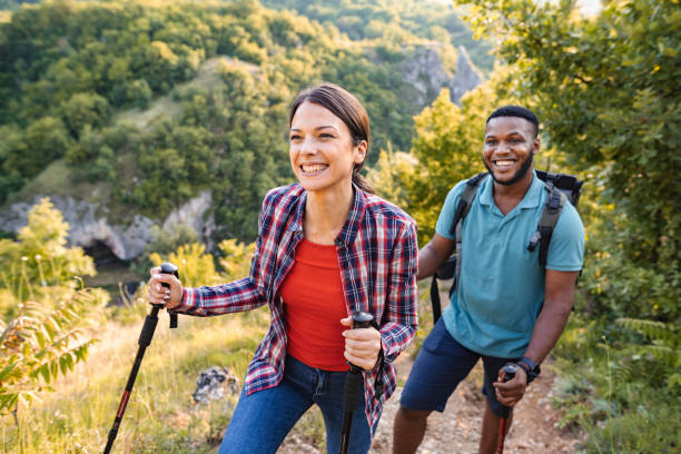 istock Young multiracial couple hiking on a mountain on a sunny day 1503363162