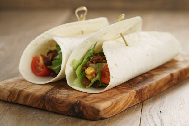 istock tortilla wrap sandwiches with beef and vegetables on olive board 1503363180