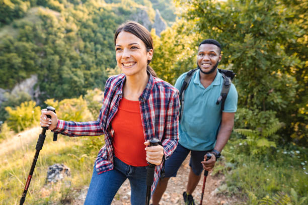 istock Young multiracial couple hiking on a mountain on a sunny day 1503363184