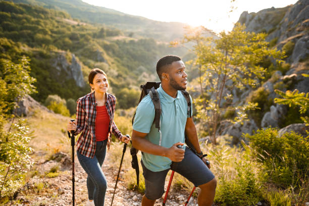 istock Young multiracial couple hiking on a mountain on a sunny day 1503363194