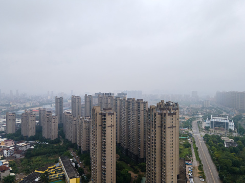 New residential buildings and highways in cities amidst clouds and mist