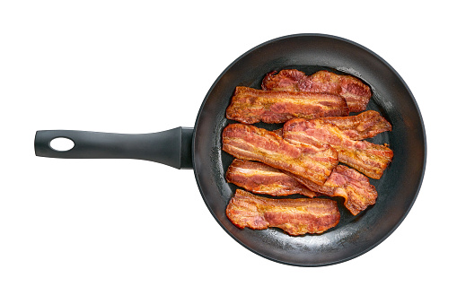 fried bacon rashers in a skillet isolated on white background, top view.\nfried bacon strips in a skillet isolated on white background, top view.