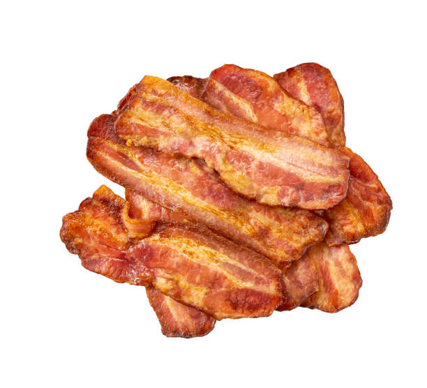 istock pile of fried bacon strips isolated on white background. 1503367625