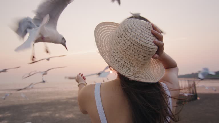 Caucasian woman looking on the sea at sunset