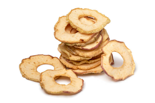 Heap of dried apple chips isolated on white background