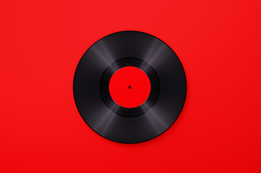 Vinyl record over red background. Horizontal composition with copy space. Vintage music concept.