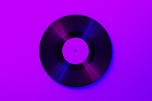 Vinyl record over purple background. Horizontal composition with copy space.
