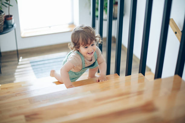 istock Baby boy trying to climb the stairs 1503372016