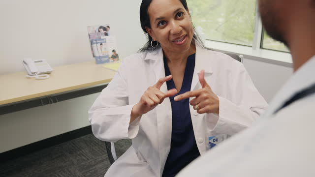 Doctor using ASL to communicate with deaf patient